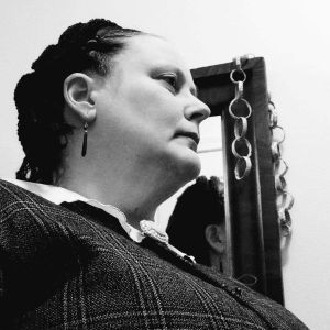 Black and white photos of Anna standing in front of a mirror.